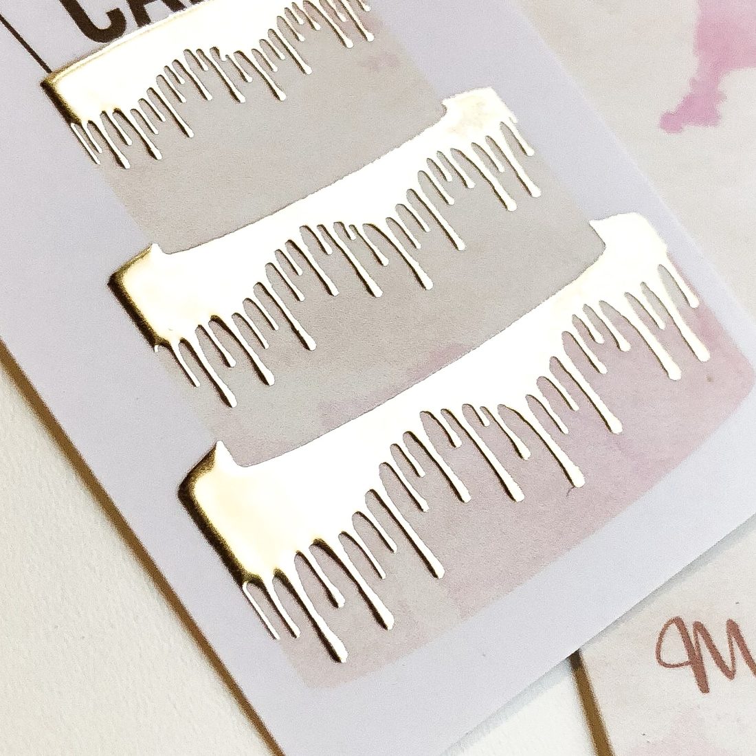 Gold foil stamping catching the light on a printed card